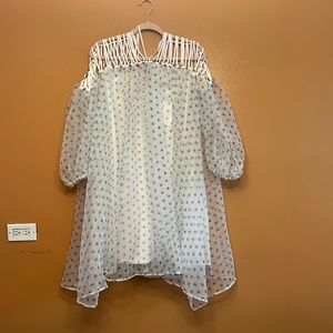 A short puff sleeve dress with gold embellishments